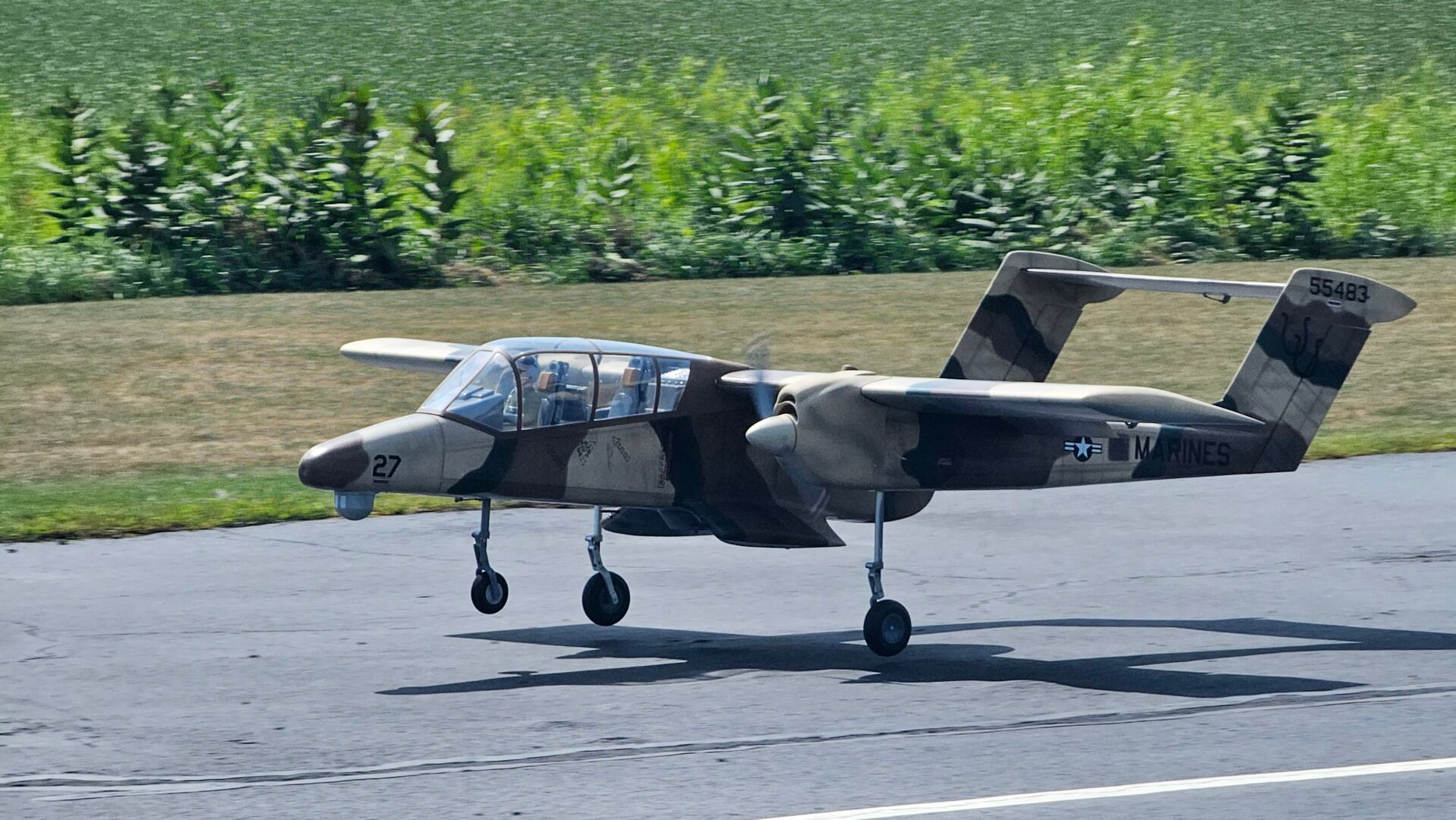 Scale RC OV-10 Bronco approaching the runway at an RC flying event