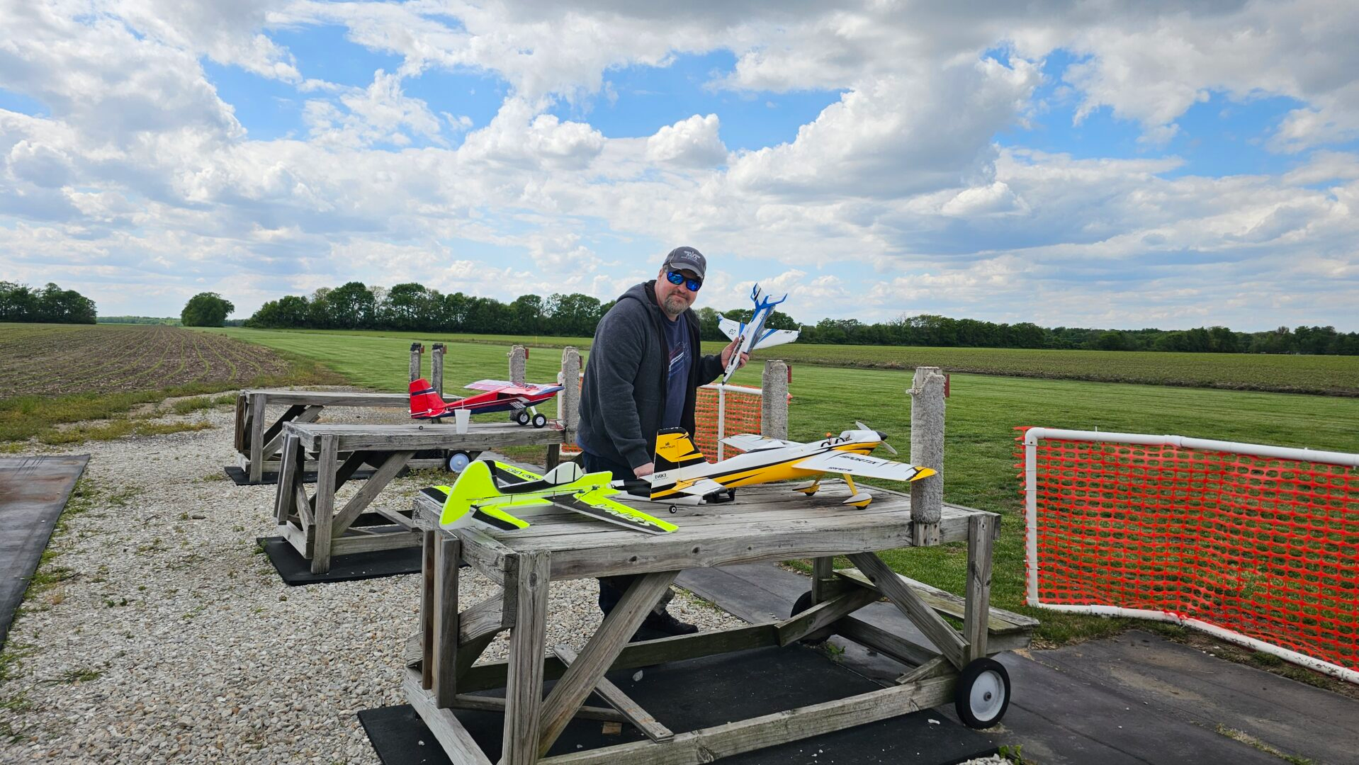 RC pilot at a flying field with several profile foam airplanes