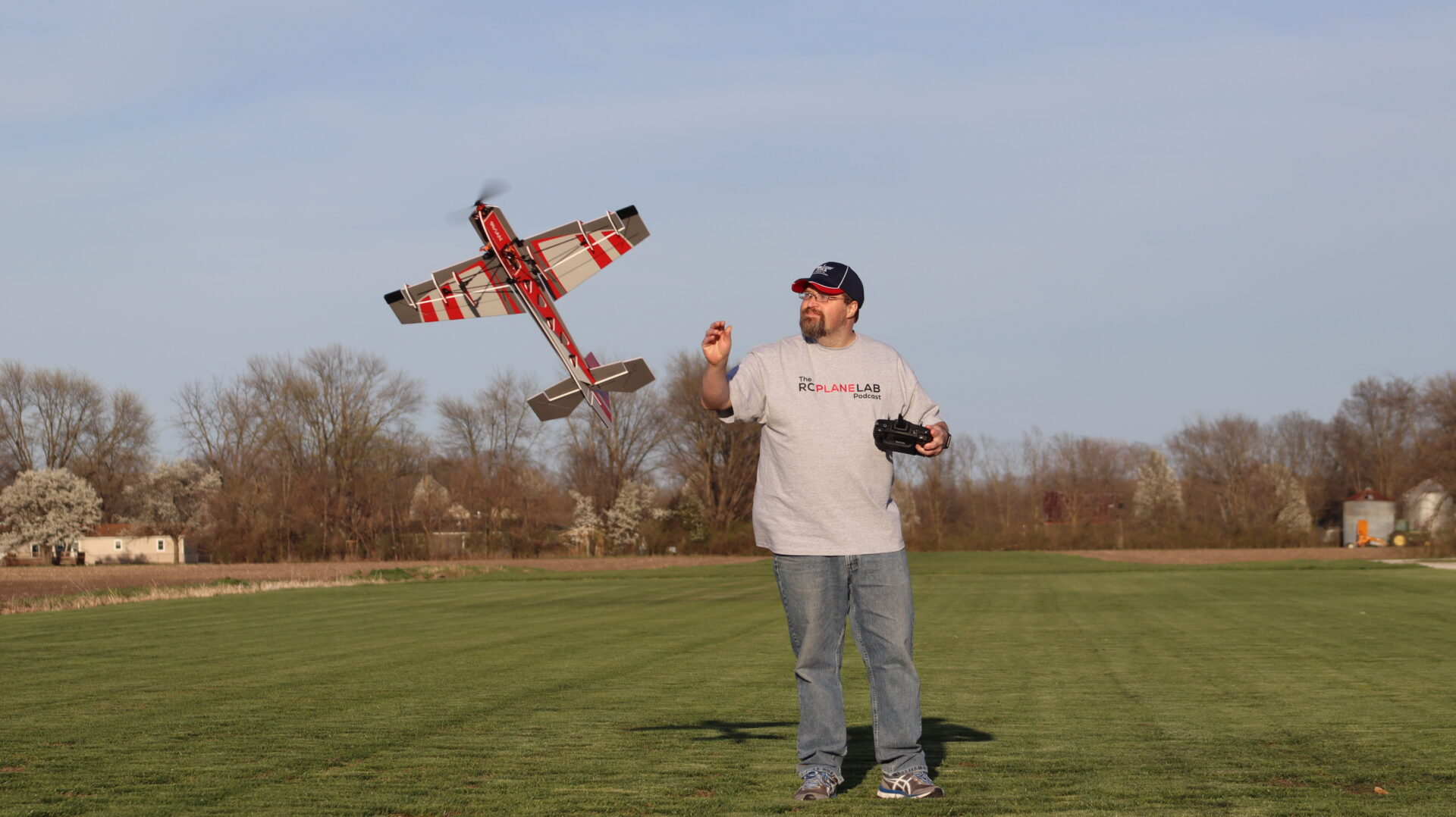 Profile foamy RC airplane at the flying field Ron flying a red profile foamy RC airplane at the field